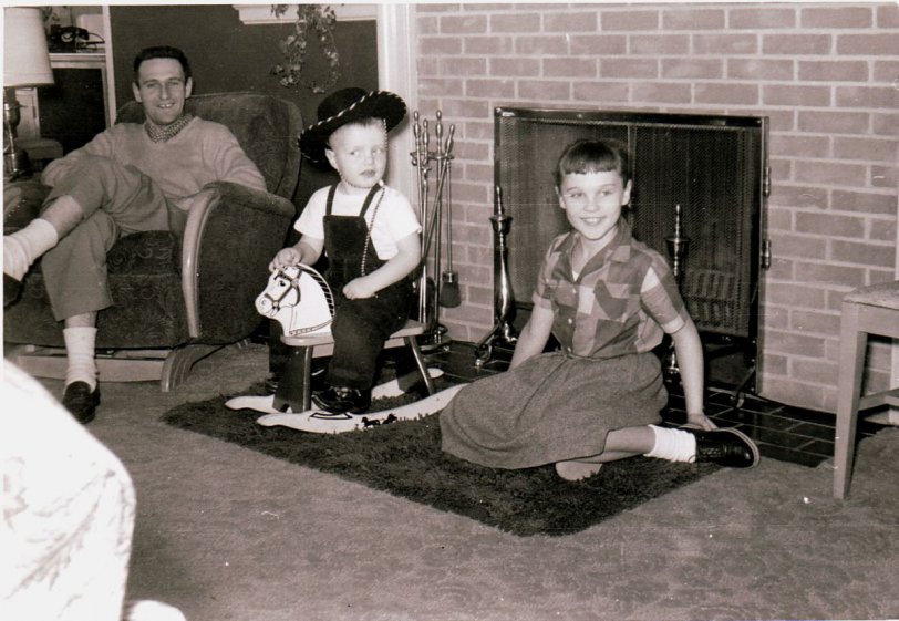 Golden Valley, Minnesota, probably about 1952.  My dad, my older sister and me.  My dad, as you can see, used to have quite a space between his front teeth.  I always loved hats...and my big sis.  My mother or one of my aunts was probably the photographer.
