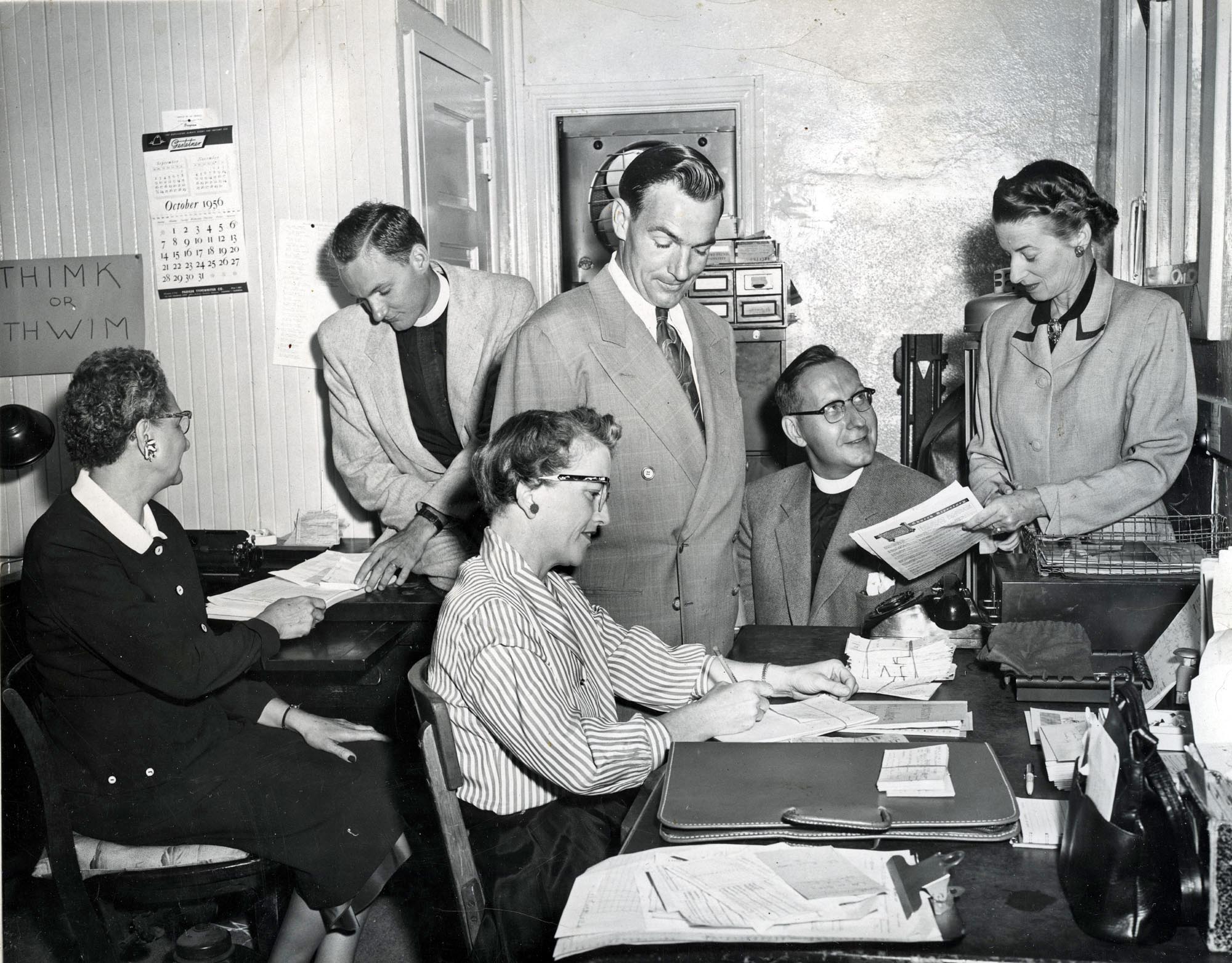 October 1956. From an 8x10 glossy photograph. "Old office in small church. Staff of St Luke's. L to R, Mabel Getchell, Rev. John Sanford, Elmer Nigg (Sexton), Rev. Morton Kelsey, Bernice Pursel, and Virginia Speer (in front). 1956"

This was St Lukes in Monrovia CA.
