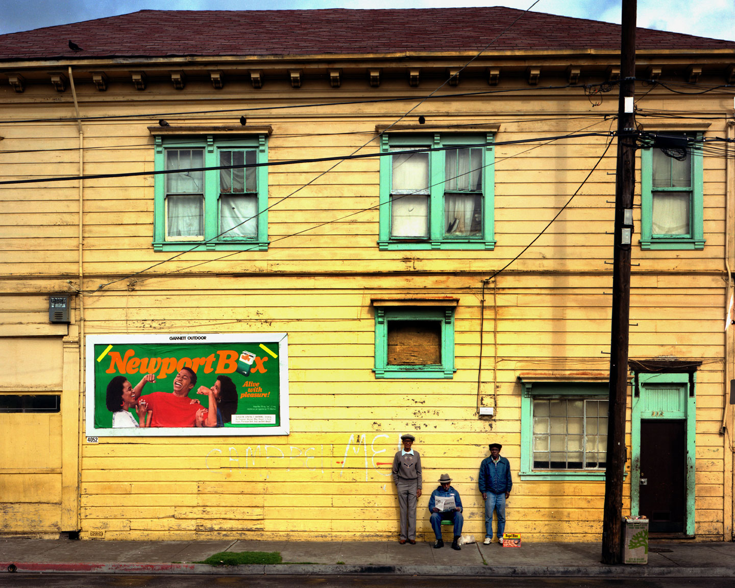 Driving to Oakland I saw these three guys against a beautifully painted building. I pulled out my Calumet 4X5 large format camera and made this picture. Funny that they never seemed to move a muscle. Oakland, CA 1990. View full size.
