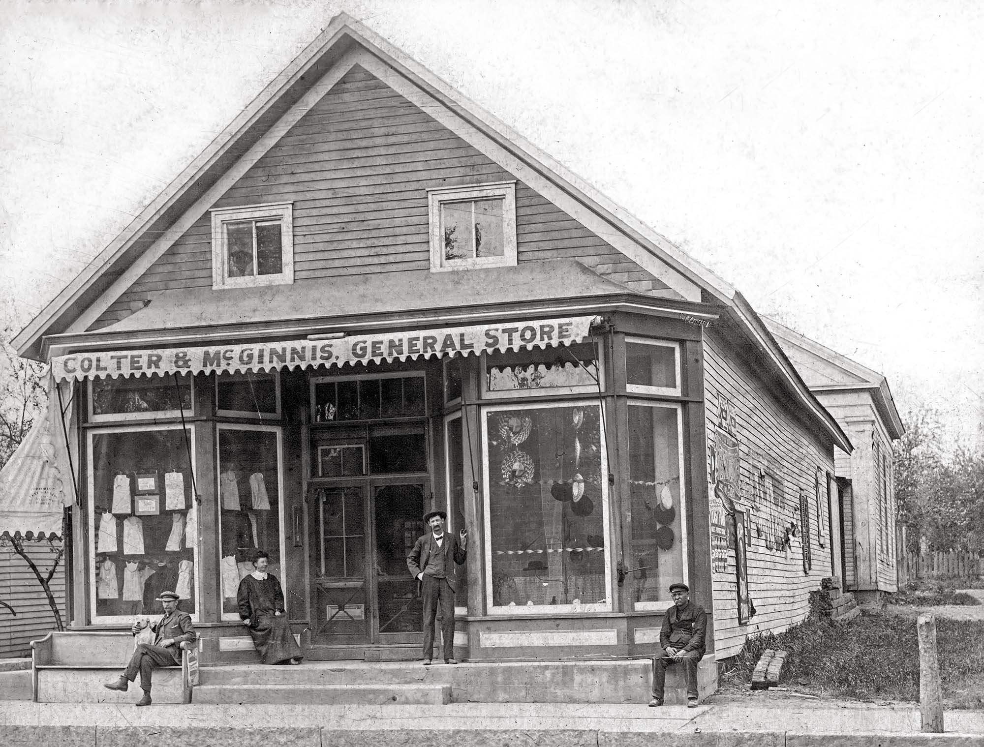 Colter & McGinnis' General Store on the 130 block of South Sampson Street, Tremont, Illinois. Circa 1900.

Pictured  (left to right) are Frank E. McGinnis, Anna Patte Rollins and  Edward Colter, (Unknown), 1900.

The store was later occupied by Gerald Beechman's Grocery, which burned down in a fire in March 1940. The Congregational Church building is located in the rear and was organized in 1844, with a church building  was erected in 1848.

"In 1859 Messrs. Wm. Pettis and Nathanial Ingalls built a store building, also a bank building on lot 12 in block 25. The store building is the one where Ed L. Colter and Frank E. McGinnis were for a number of years." — from the "Historical Account of the Origin, Growth and Development of The Village of Tremont, Illinois", 1925

"Hugh McLean, the Village Clerk, will have his office at Colter & McGinnis’ store and anyone having business with him can have the same attended to whether he is there or not, as he has made arrangements with Mr. Colter to look after the affairs of the office if he is not in town." — Oct. 25, 1907