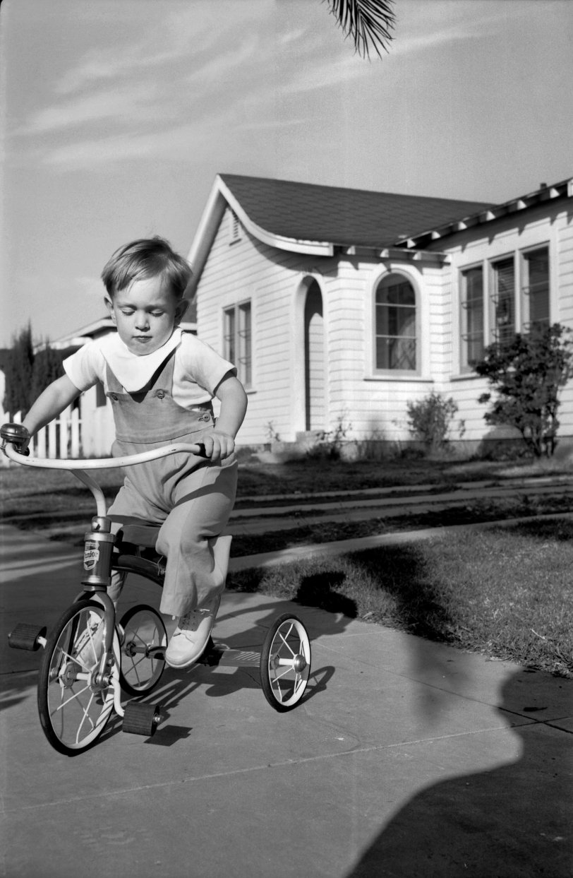 An unknown boy riding his tricycle in (mid-1930s?) San Diego. View full size.
