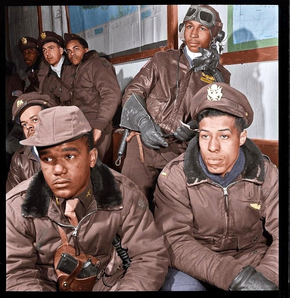 332nd Fighter Group airmen at a briefing in Ramitelli, Italy. March 1945. Foreground: Emile G. Clifton of San Francisco and Richard S. "Rip" Harder of Brooklyn. View full size.
