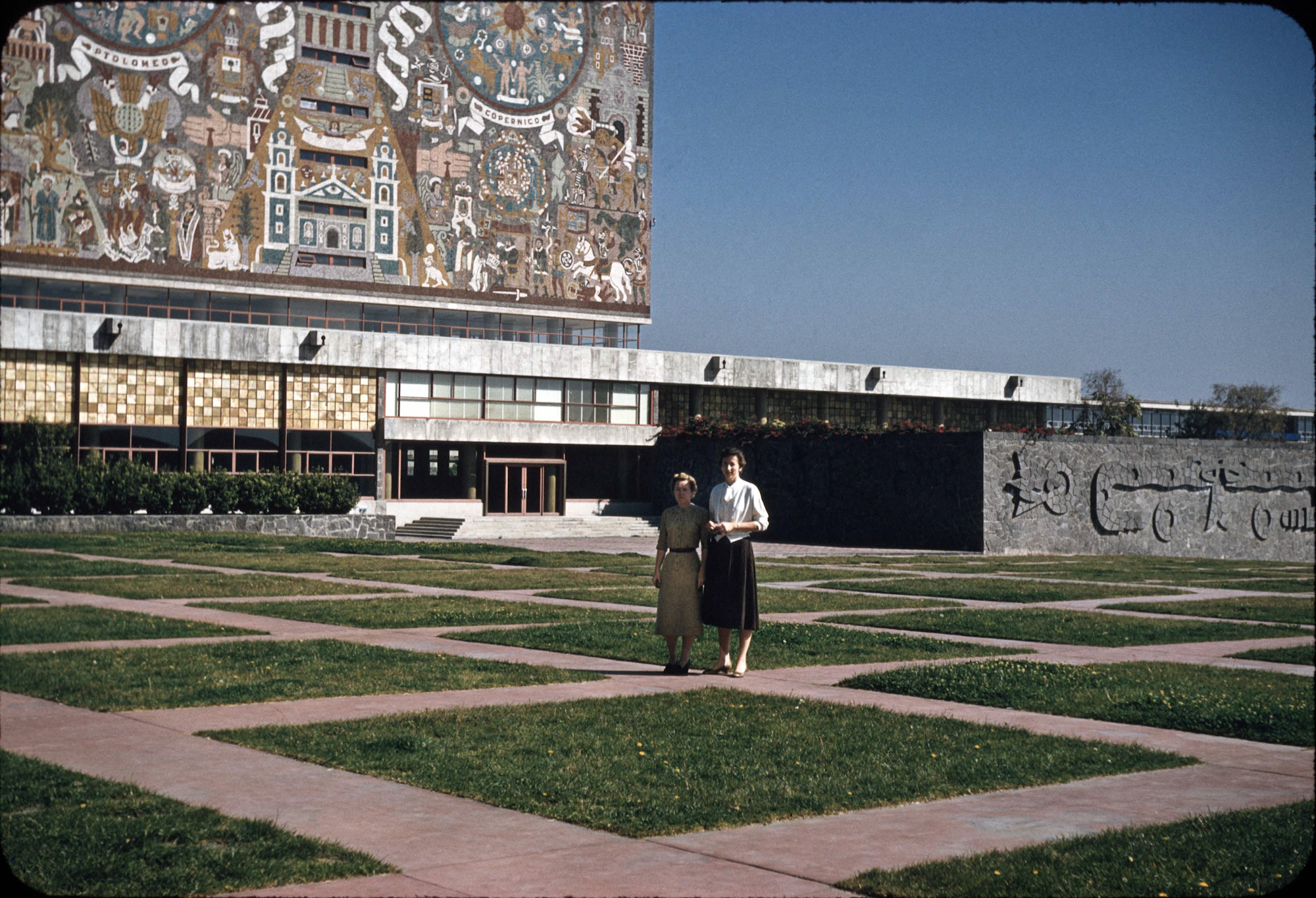 Ciudad Universitaria (University City), Mexico is the main campus of the National Autonomous University of Mexico.  Located in the southern part of Mexico city its construction on a solidified lava bed was finished in 1954.

My Aunt Lee is on the right (I'm assuming that Aunt Emmy took this picture since that is not her by Lee's side). My Aunts, at ages 38 and 40, were on their first international trip. At the time of this trip they had worked at least 15 years as executive secretaries at GM divisions in Anderson, Indiana.

The mural pictured here is recognized as the largest mural in the world, covering all sides of the Library. The mural is based on Aztec and Spanish motifs and UNAM's coat of arms.  The artist was Juan O'Gorman, a painter and architect. 

The image was digitized from a 35mm Kodachrome slide. View full size.