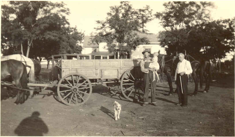 My great-grandfather showing off his wagon in a three-generation photo near Wilcox, Nebraska.