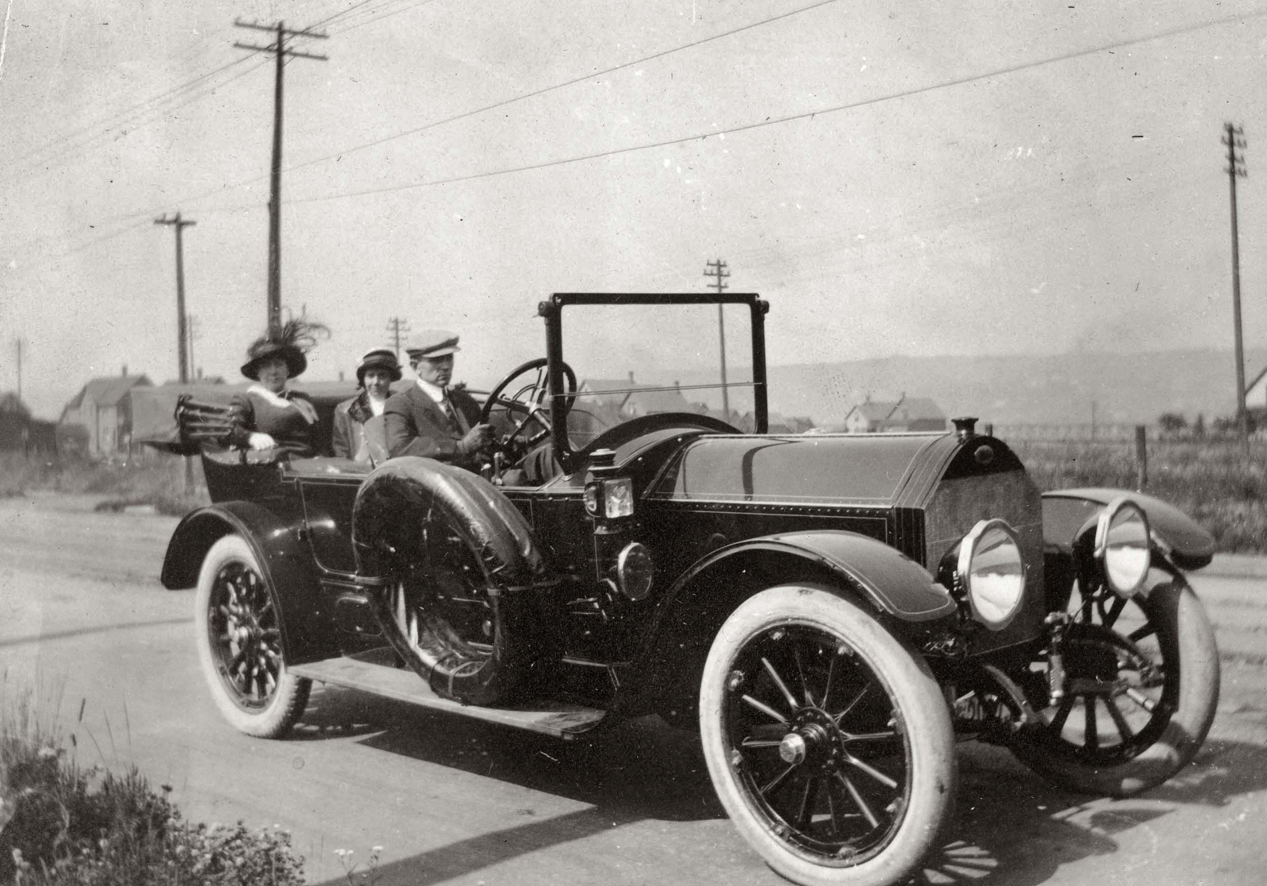 From a turn-of-the-century family photo album. Probably taken in Michigan. Can someone identify the automobile? View full size.