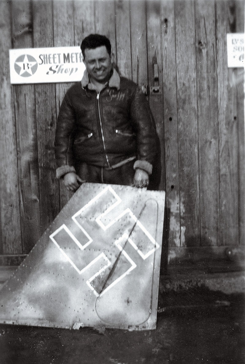 My dad Vince Raya at an airbase in England during WWII.
He was an Army Air Corp sheet metal mechanic. It appears the tail section he's holding is from an FW190. Date of photo unknown. View full size.