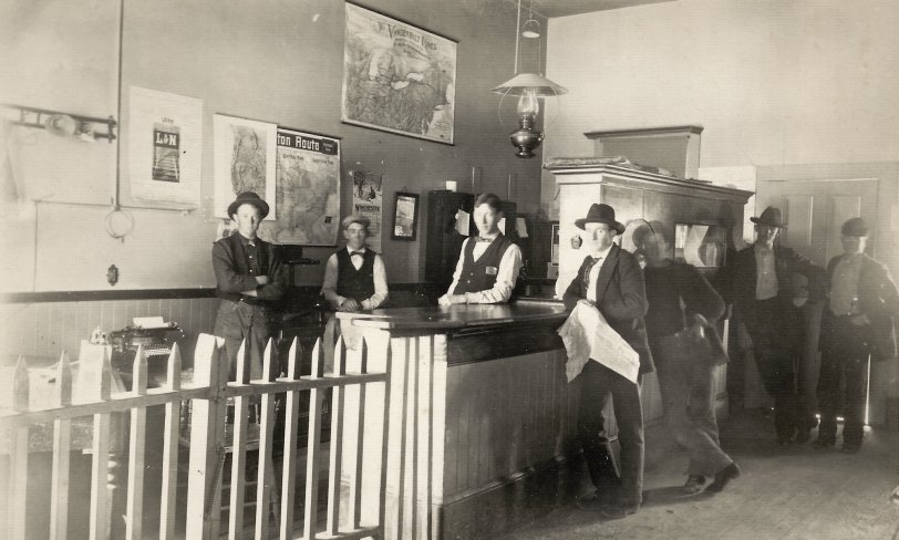 On the back is written: "Virginia &amp; Truckee RR, Interior of the ticket office. Virginia City, Nev 1898." View full size.
