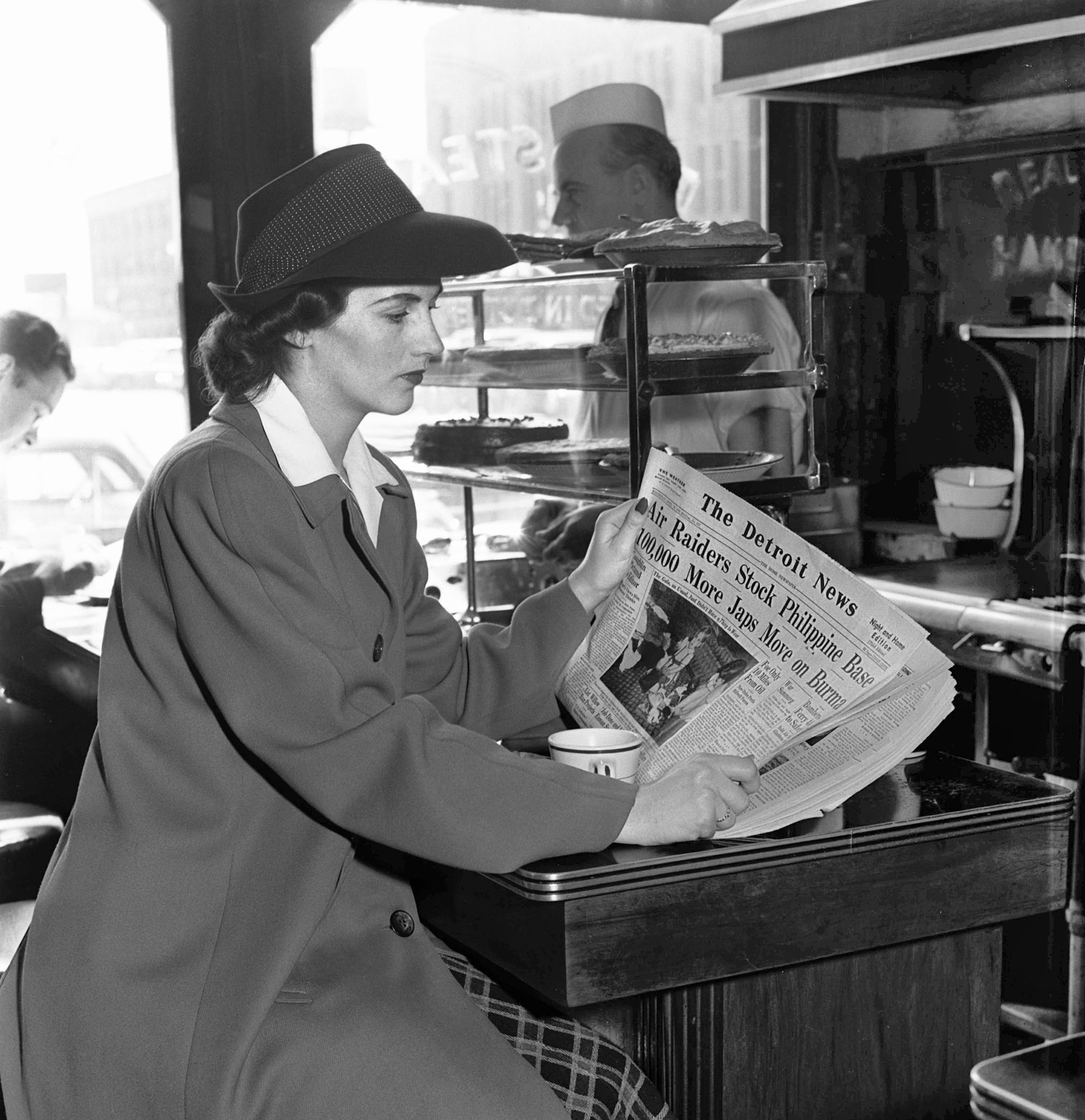 April 1942. An unknown diner reading World War 2 headlines from the Detroit News in a downtown Detroit cafe. Photo taken by my grandfather, Howard McGraw, of the Detroit News. Scanned from a 4x5 negative. View full size.