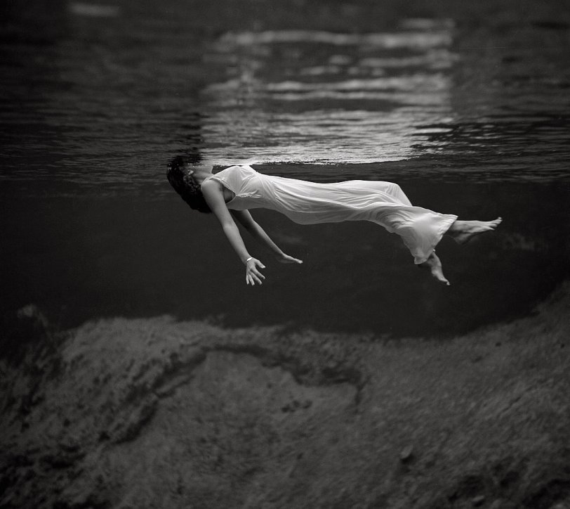 A model floating in the water at Weeki Wachee Spring, Florida. This image, by fashion photographer Toni Frissell, was published in Harper's Bazaar in December 1947. Mug | Weeki Wachee Mermaids | View full size.
