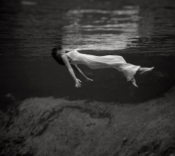 A model floating in the water at Weeki Wachee Spring, Florida. This image, by fashion photographer Toni Frissell, was published in Harper's Bazaar in December 1947. Mug | Weeki Wachee Mermaids | View full size.