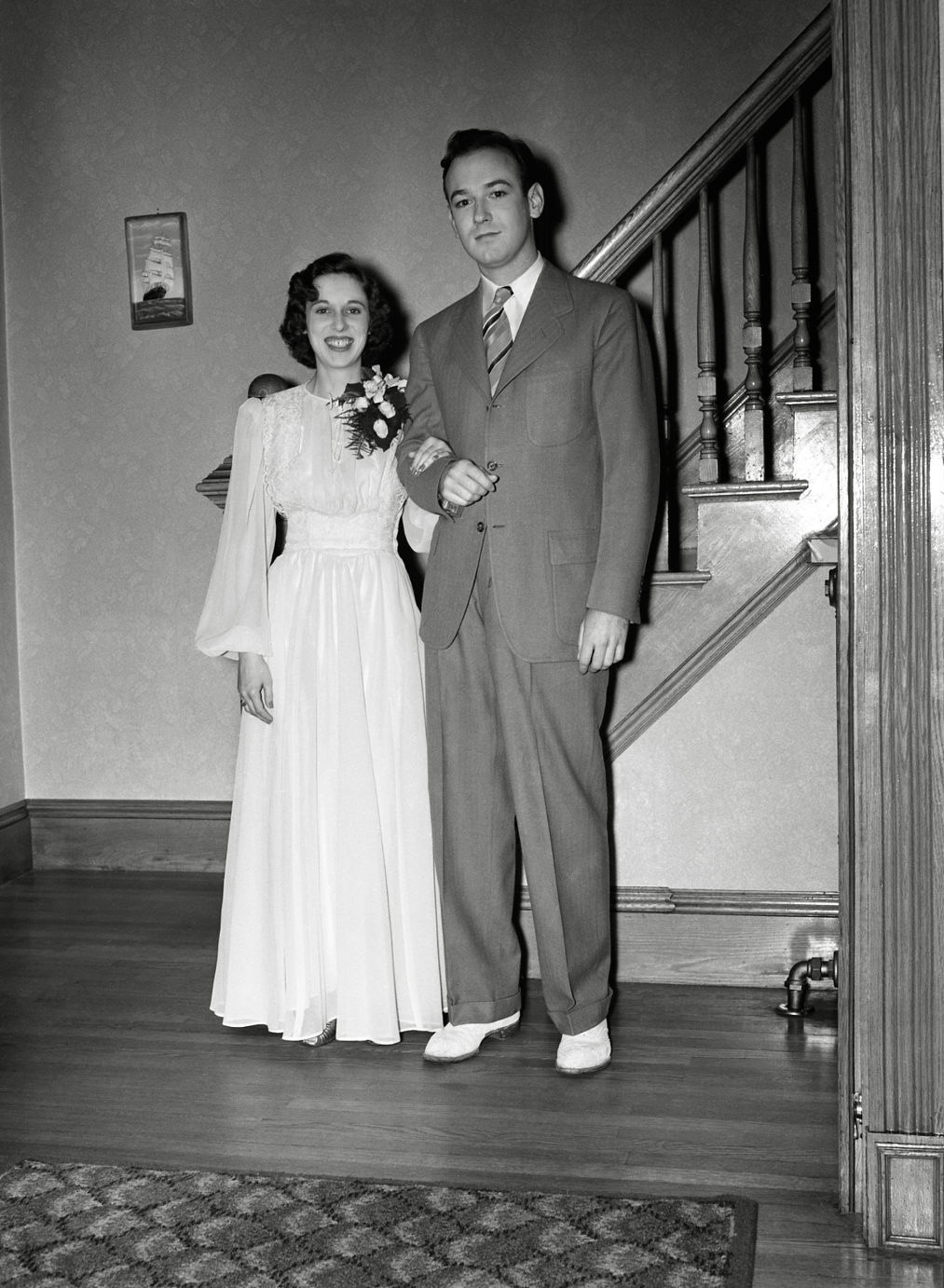 Young couple going to a prom or other important social event. She is excited, he, well who knows what he is thinking. From my negatives collection. View full size.