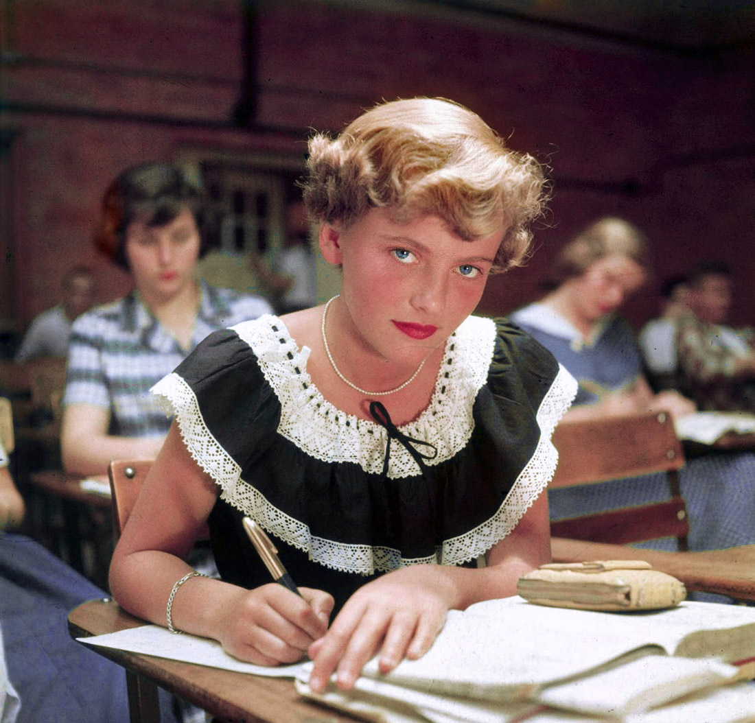 Winnetka, Illinois. June 1950. "Student Rue Lawrence wearing frilly summer dress and bright lipstick in classroom at New Trier High School." Rue was on the cover of the October 16, 1950, issue of Life. Color transparency by Alfred Eisenstaedt, Life magazine photo archive. View full size.