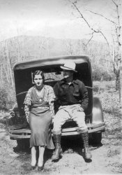 My great aunt and uncle Heraldine and Jesse Carter. She looks a little too dressed up to go camping and not too thrilled either. Taken sometime in the 30's from the fashions of the time. View full size.
DecampedIt is possible these people were not camping, just traveling -- roads were not very good then.  I heard reference one time that traveling in the late 20's and 30's was similar to falling down a flight of stairs.
(ShorpyBlog, Member Gallery)