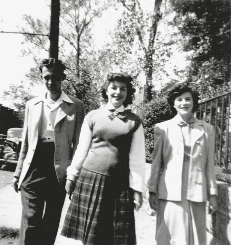 My mother, then named Arlene Weinstein and called "Rusty" by her friends because of her rust red hair, poses with two of her Brooklyn neighbors on a street near their home. She is in the center, dressed to the nines, as she always was. Back of photo says Rubie Cohen, 953 45th St, and Jack Katzman, 942 45th St, in writing that dates to the time of the picture, and Doris Landman, Arlene, and Rube Cohen in writing added by my mother a half century later. My guess is there are actually four teens hanging out in Brooklyn on this mid 1940's day. Perhaps Jack is taking the picture. Mostly I like this picture for the car (which did not belong to any of them or their families). View full size.
