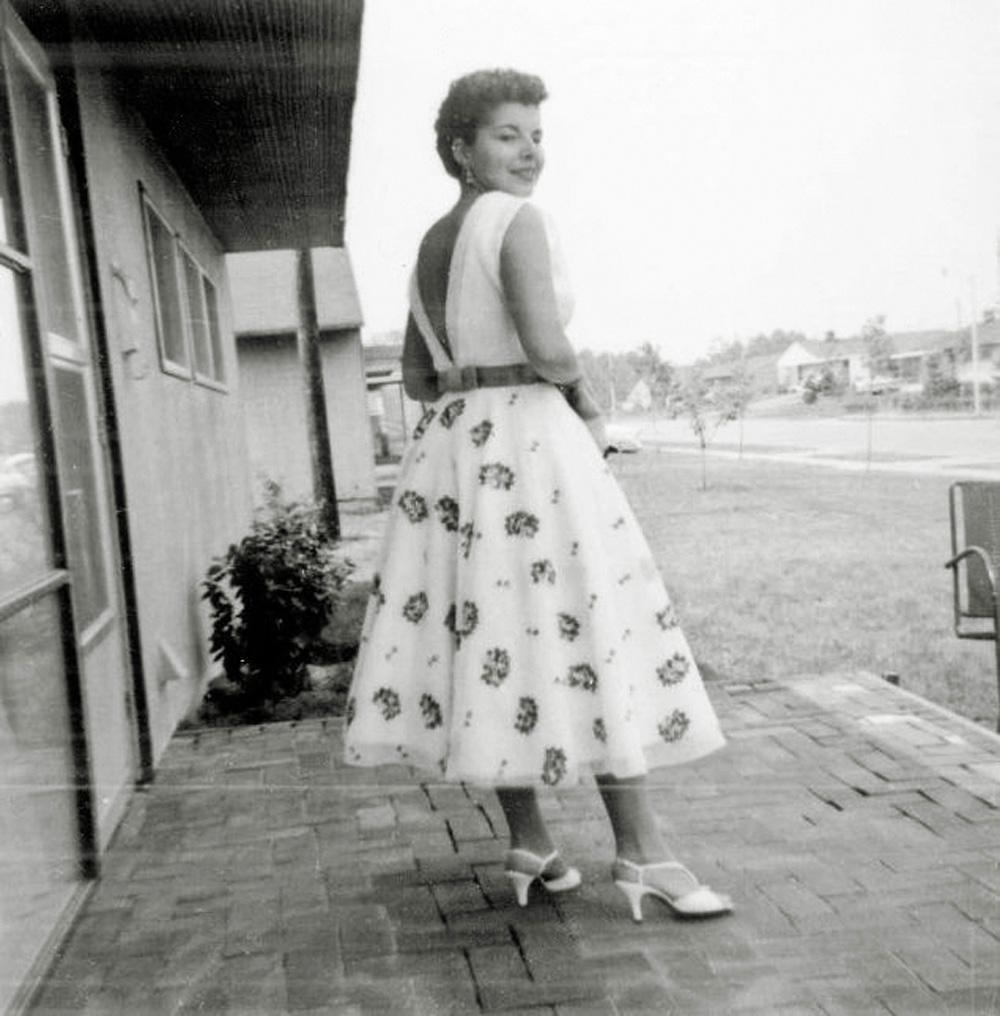 My mother designed and sewed this dress for herself in the late 1950's. I am guessing, based on the hem length, around 1958. She then had my father take her picture. Her intention was to show off her design and dress-making skills. But what this picture really shows is the mid century modern and still new world of Levittown, Pennsylvania during the first few years after it was built in 1953. Every house got two fruit trees and two pine trees that were basically single stalk sticks. With no landscaping the lots look huge, but they are only a quarter acre. Brick patio was an owner added modification. (In other words my father laid those bricks out in a bed of sand). She is standing at 110 Dogwood Drive, and you are looking diagonally northwest at the homes with lower street numbers. View full size.