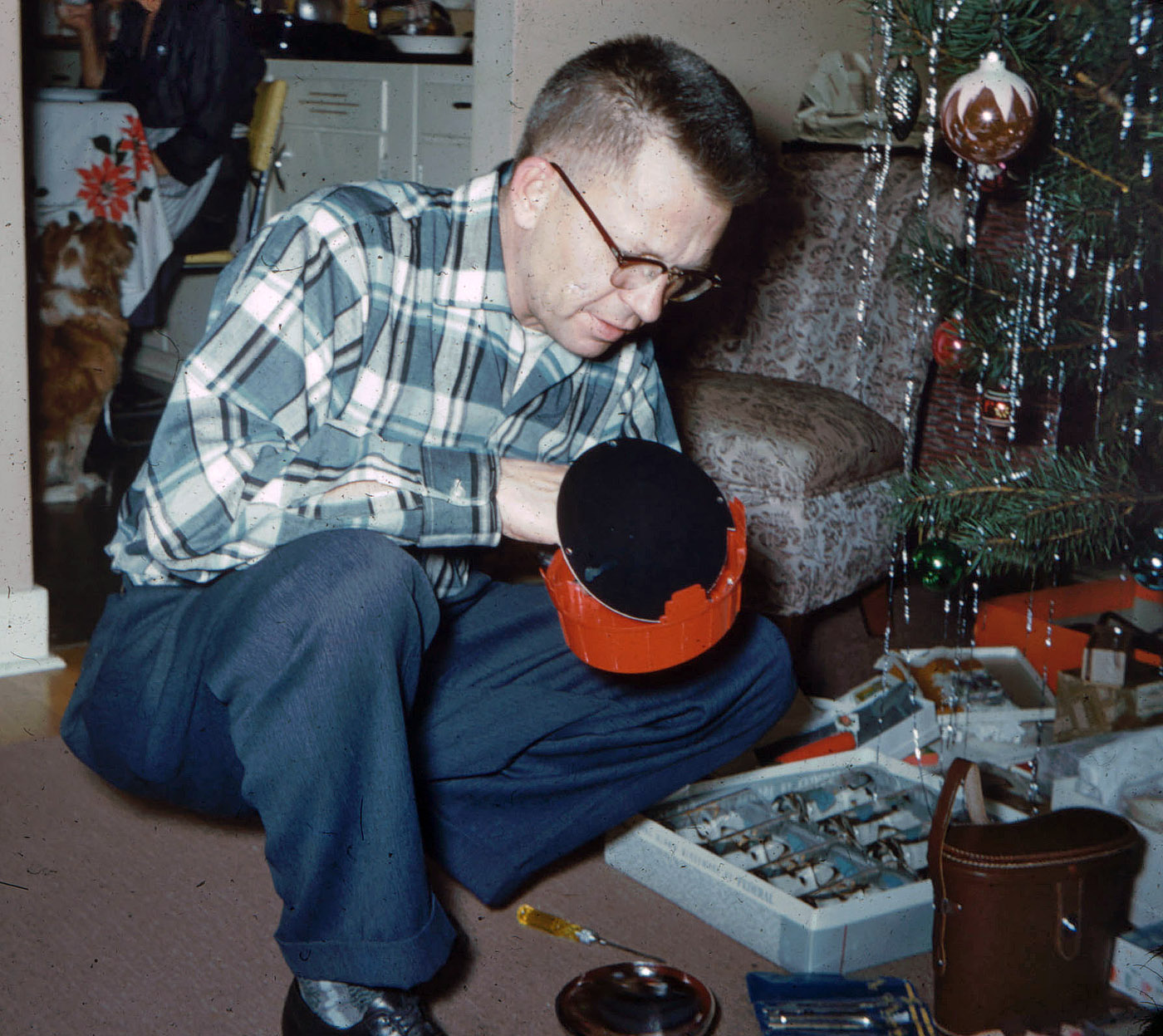 In 1959, my engineer father was, as his expression shows, not happy that a part to my brother's new magic set was not working by late Christmas morning. This was my second picture with the Argus C-Twenty camera I received that day so long ago. For $29.95, the camera kit came with one 20-exposure roll of Kodachrome daylight, six No. 5 blue flashbulbs, plug-in flash gun, and a slide previewer.  My parents spent an extra $4.79 for the top-grain leather case. For some reason, they never discarded the Fall-Winter 1959 Montgomery-Ward catalog in which the camera was featured. The catalog is now in my home. The camera served me well through high school, college and beyond. View full size.