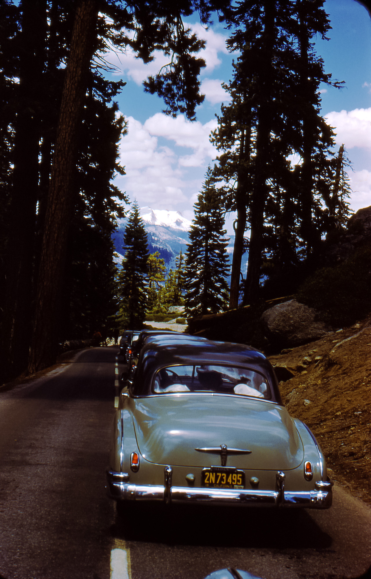Yosemite park in what I'm assuming is 1954 based on the '55 license plate sticker. It's funny thinking that the original intent of the photo was to capture the beauty of the park but all most people would look at today are the cars. Scanned from the Kodachrome slide. View full size